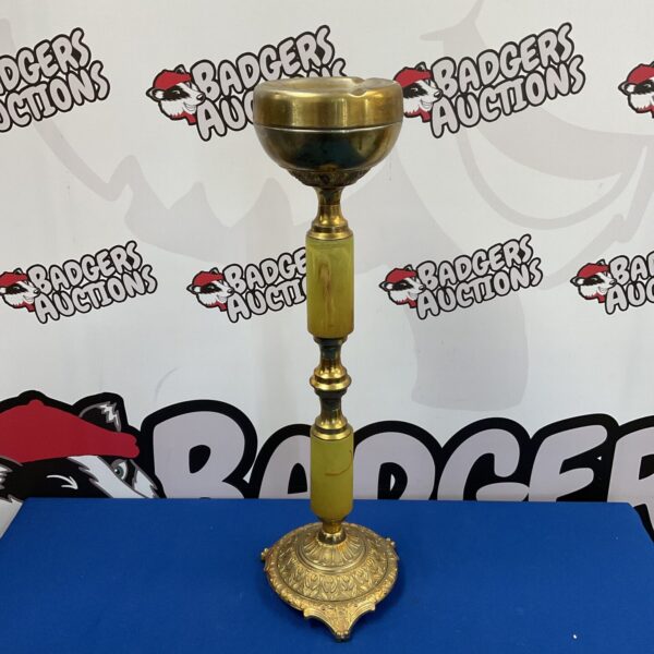 Vintage brass pedestal ashtray, a classic retro bar accessory.