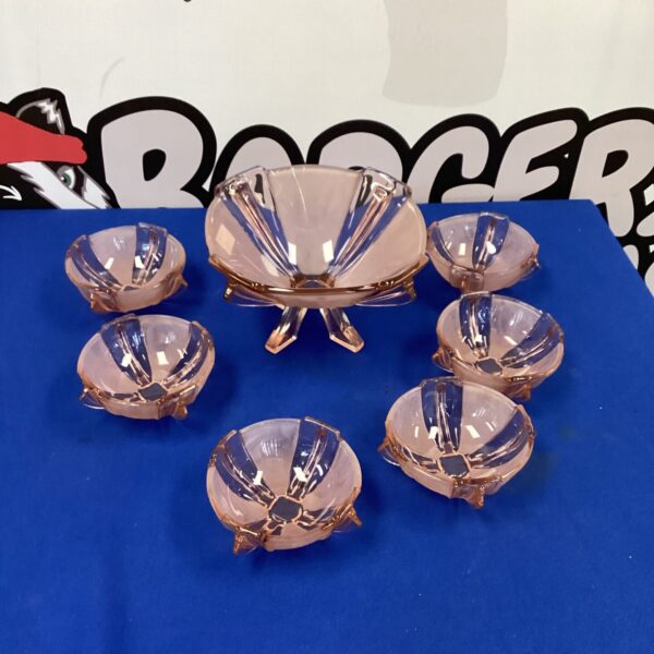 Vintage pink glass Art Deco winged bowls set for display.