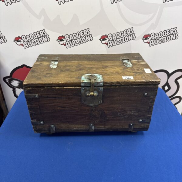 Antique wooden storage box with brass clasp and hinges.