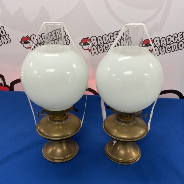 Pair of vintage brass oil lamps with glass shades.