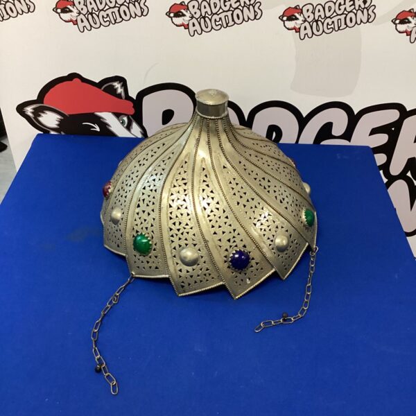 Intricate Moroccan pendant light with pierced metal design.