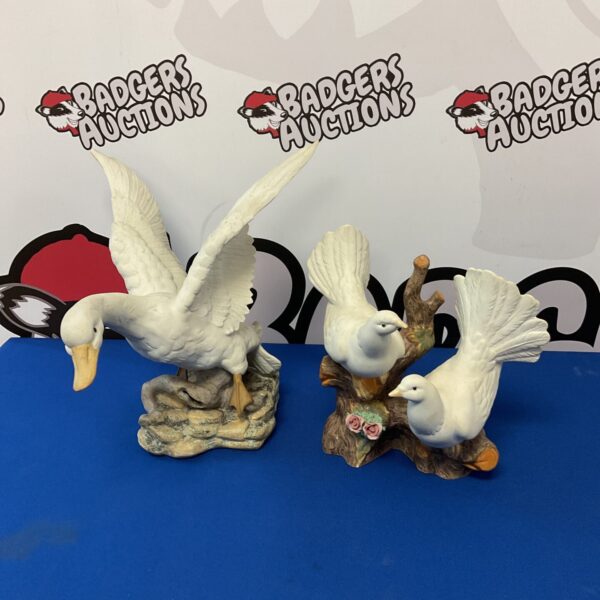 Detailed Portuguese porcelain duck and dove ornaments for collectors.
