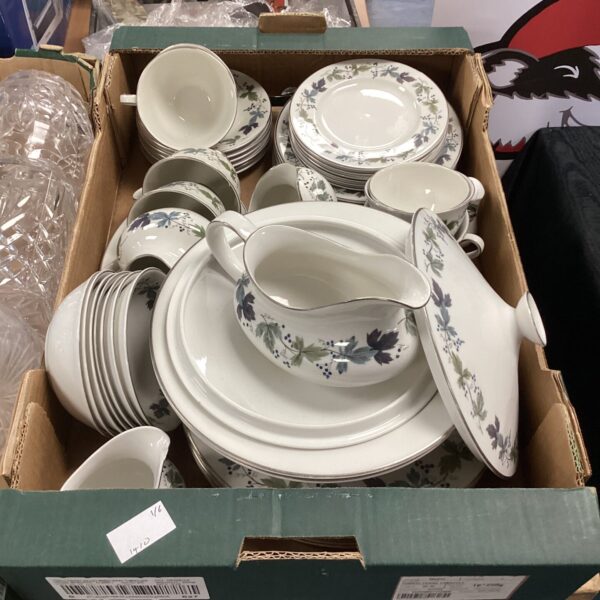 Vintage Royal Doulton dinner service with floral pattern on white china.