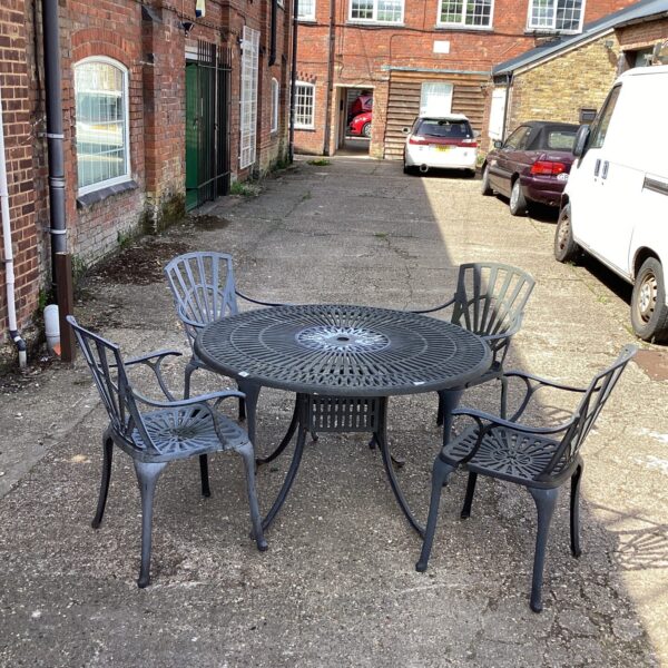 Close-up of vintage metal garden table and chair set.