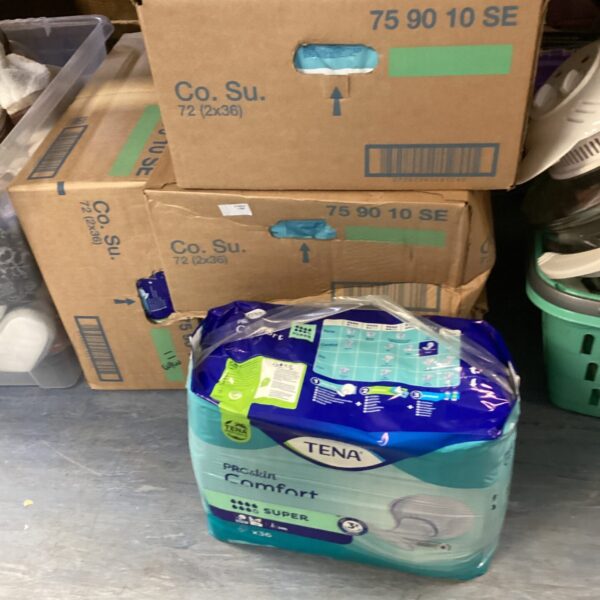 Stack of four boxes of Tena incontinence pads.