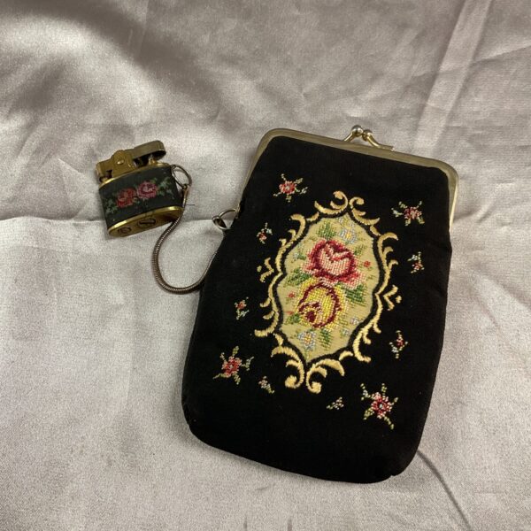 Close-up of vintage embroidered purse with floral design.