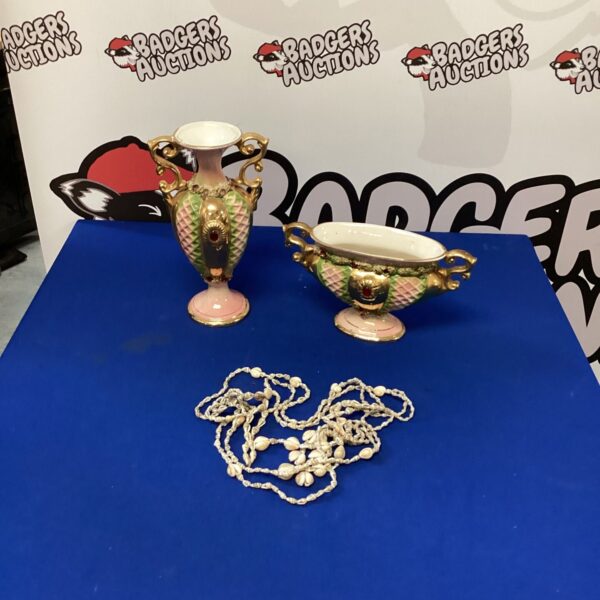 Vintage Italian porcelain vases with a delicate seashell necklace.