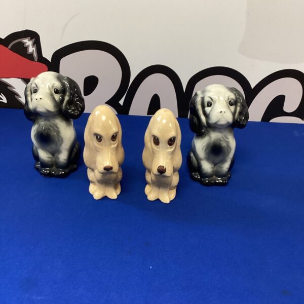 Vintage Sylvac dog figurines displayed together, collectible pottery.