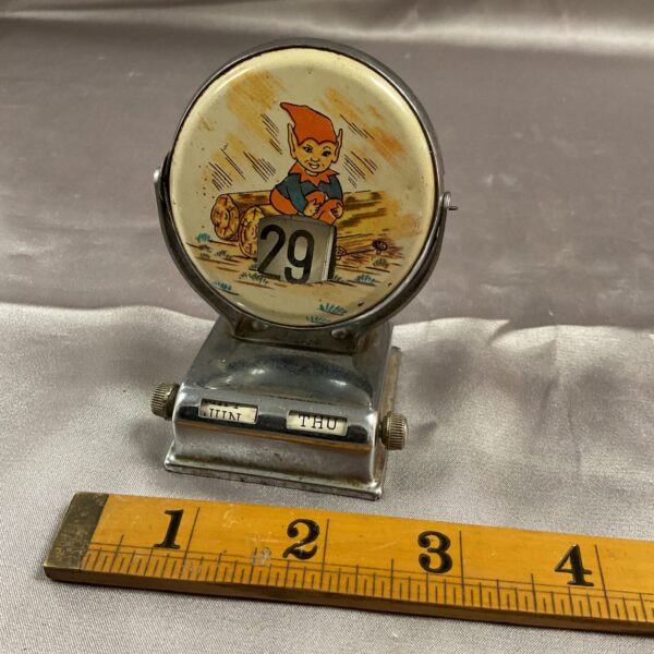 Vintage day date desk calendar with a whimsical character.