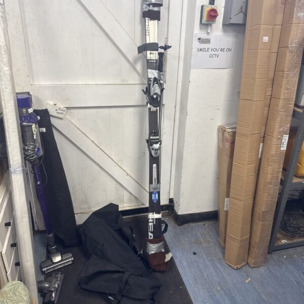 Full view of Head C140 carbon fibre ski set with poles and bag.