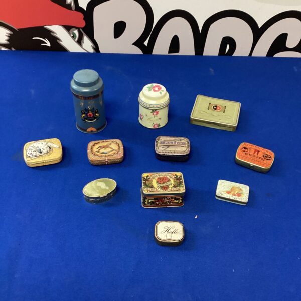 Selection of colourful vintage miniature tins, collectible antique containers.