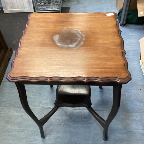 Antique mahogany lamp table with fluted edge and curved legs.