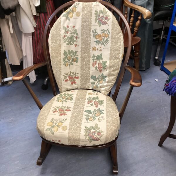 Vintage ercol stickback rocking chair with patterned upholstery.