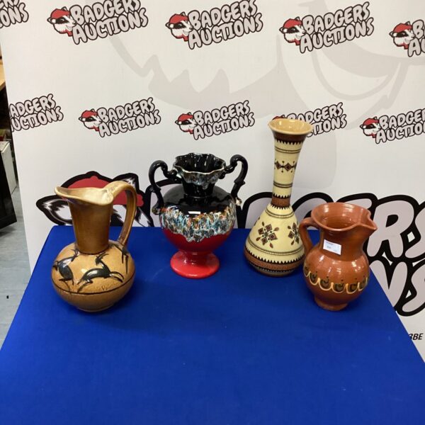 Vibrant handmade ceramic vase with colourful painted designs.