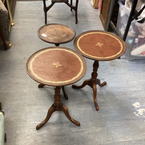 Lot of three vintage telephone tables with leather tops.
