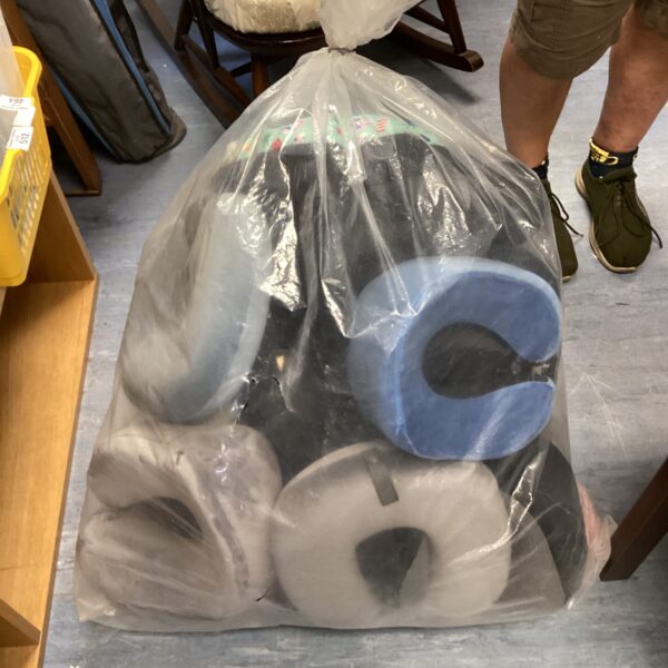 Sealed bag of new travel cushions for comfortable journeys.