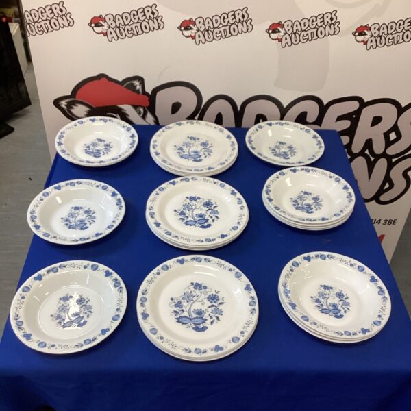 Vintage Arcopal plates with a floral pattern on a table.