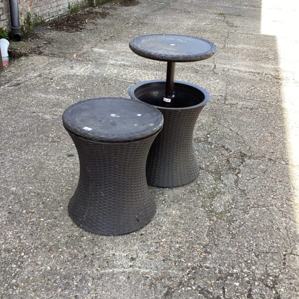 Pair of dark plastic cooling tables for outdoor drinks.
