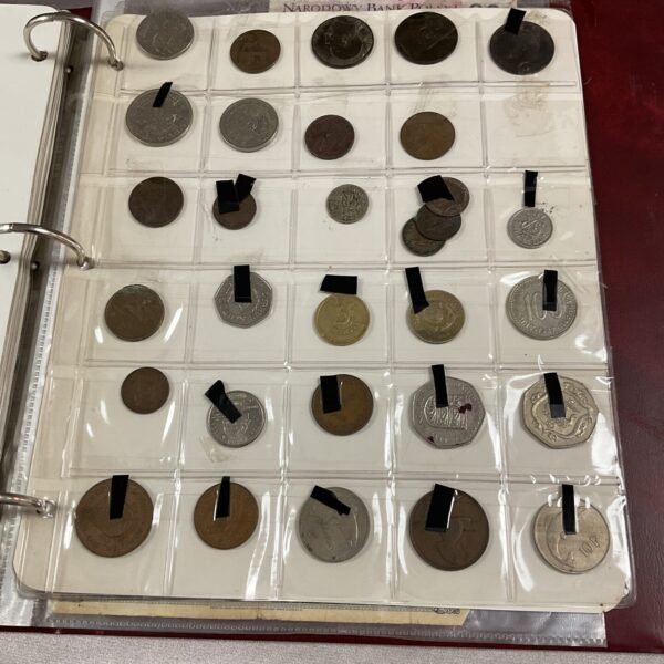 Front view of a coin album with assorted coins visible.