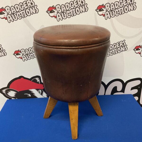 Vintage brown leather elephant foot stool with wooden base.