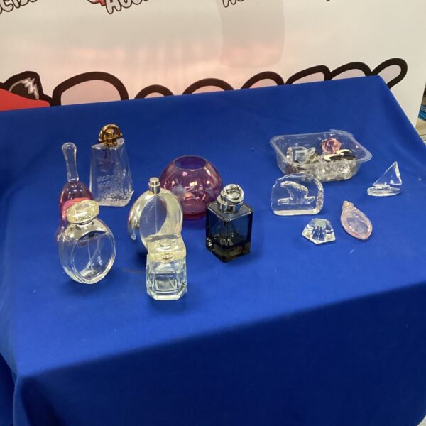 Vintage perfume bottles and crystal items on display.