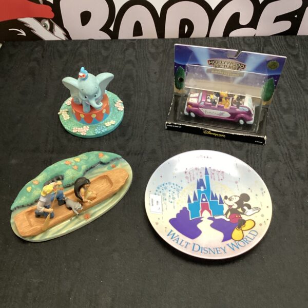 Overview of the Disney collectibles lot including ornaments and plate.
