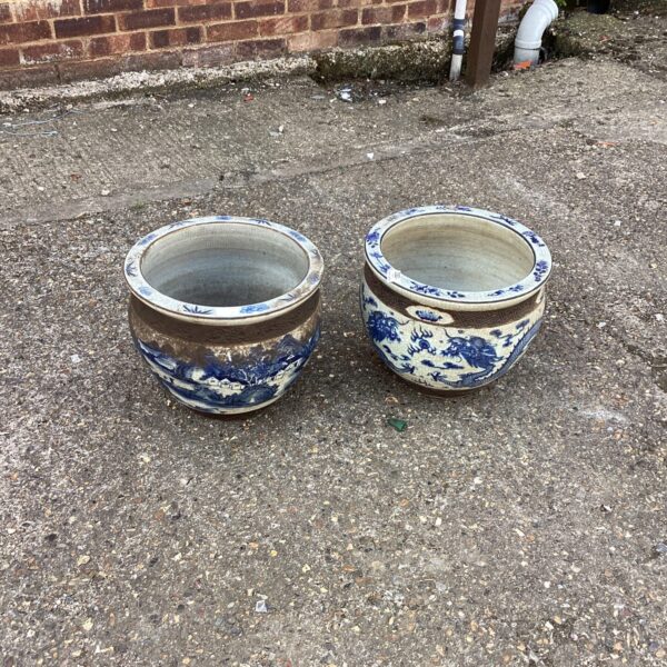Two vintage blue and white ceramic garden pots for outdoor display.