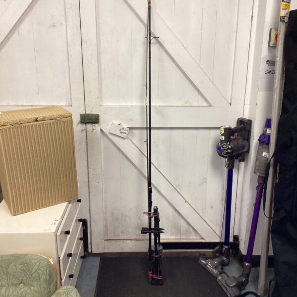 Daiwa Blackwood carp rod leaning against a white door with rod rest.