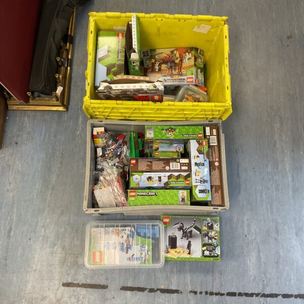 Large lot of LEGO Minecraft sets and minifigures in a storage box.