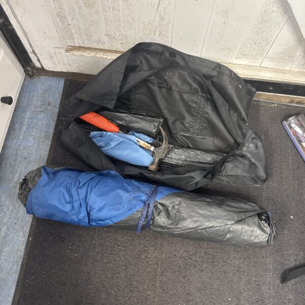 Compact camping tent with included poles and hammer.