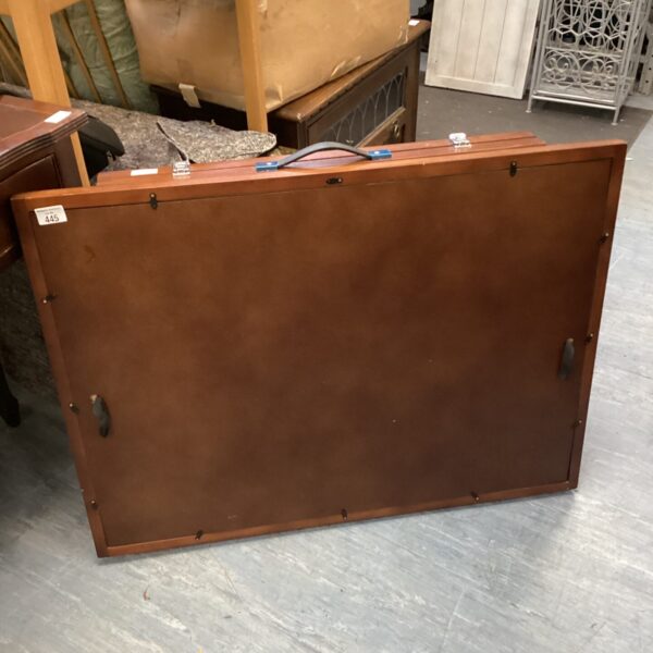 Vintage brown folding puzzle table with a wood finish.