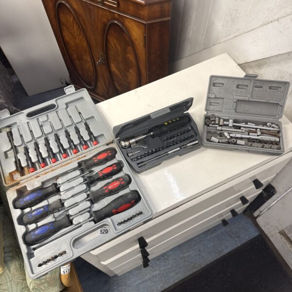 Lot of three screwdriver and socket sets in black cases.
