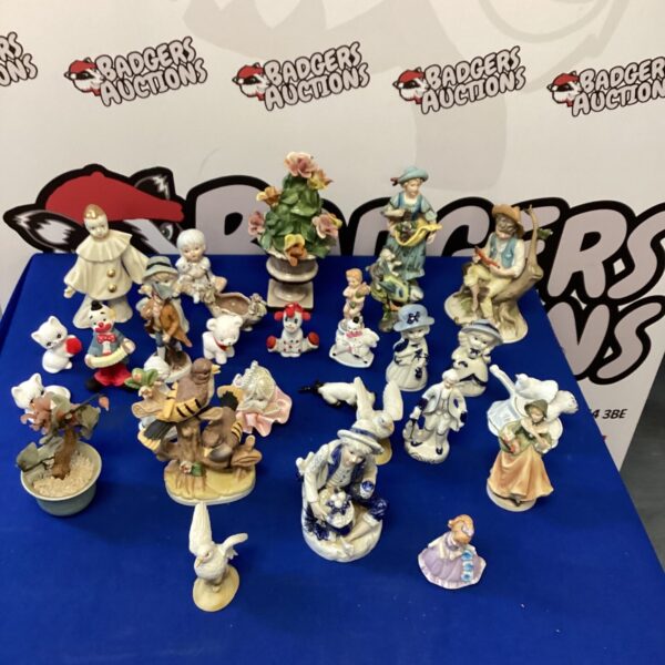 Large lot of vintage porcelain figurines and bird ornaments on display.