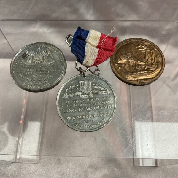 Front view of three Royal coronation medals with ribbon.