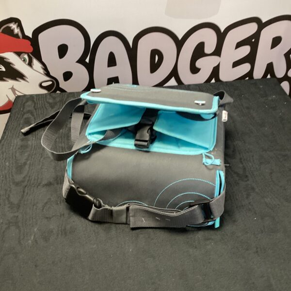 Folded Munchkin booster seat for kids, portable travel solution.