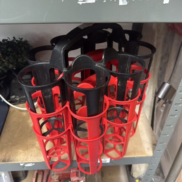 Red XLR8 can carrier holding three cans.