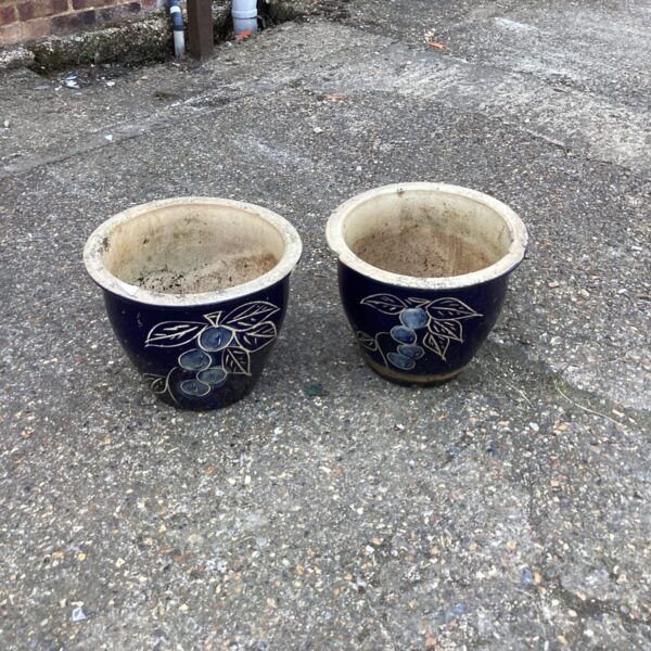 Two large blue garden pots with white floral design.