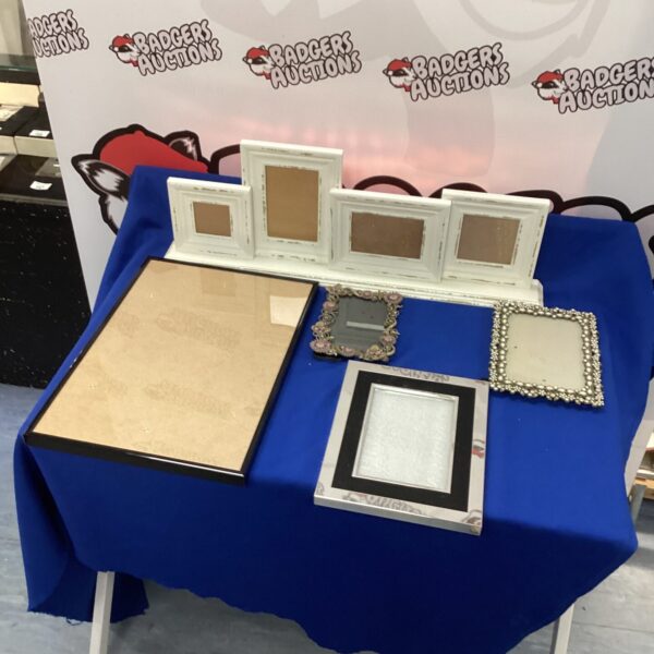 Collection of vintage photo frames on a blue surface.