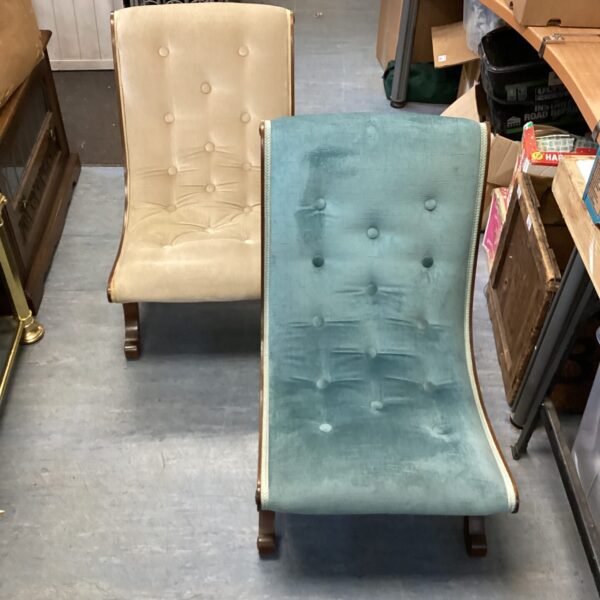 Pair of vintage nursing chairs with pale upholstery.