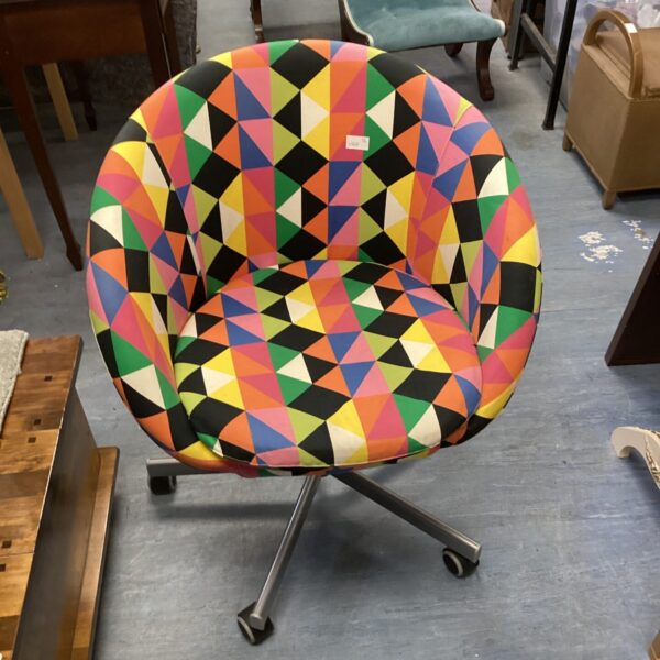 Vibrant 1960s swivel chair with geometric patterned upholstery.