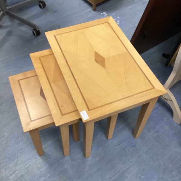 Vintage wooden nest of tables in graduating sizes.