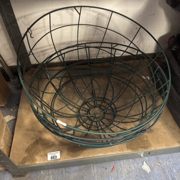 Three metal wire hanging baskets for garden plants.