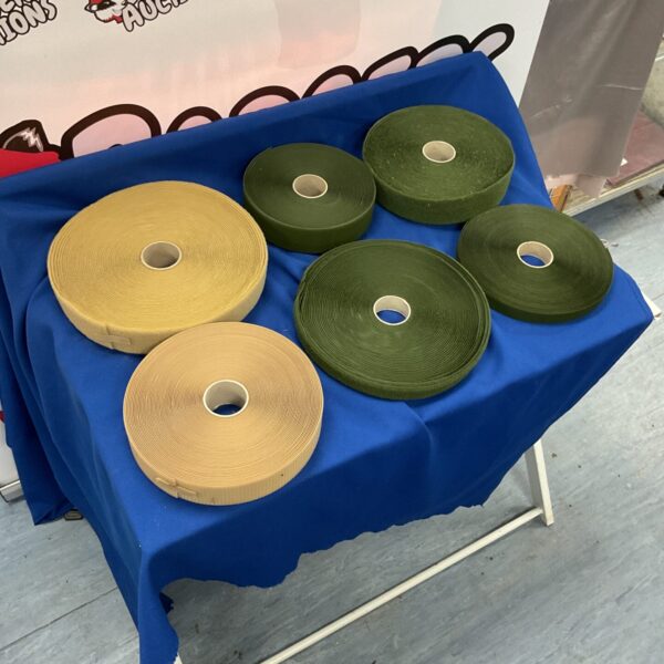 Bulk lot of black and white velcro tape rolls for various uses.