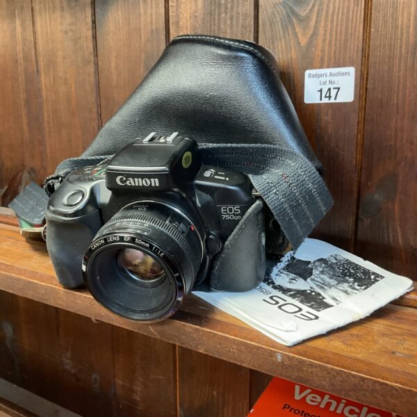 Vintage Canon EOS 750 QD 35mm film camera in used condition.