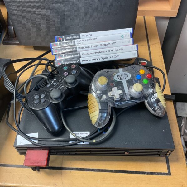 Sony PlayStation 2 console bundle with games, retro gaming.