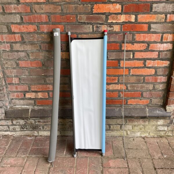 White folding projector screen with adjustable legs.