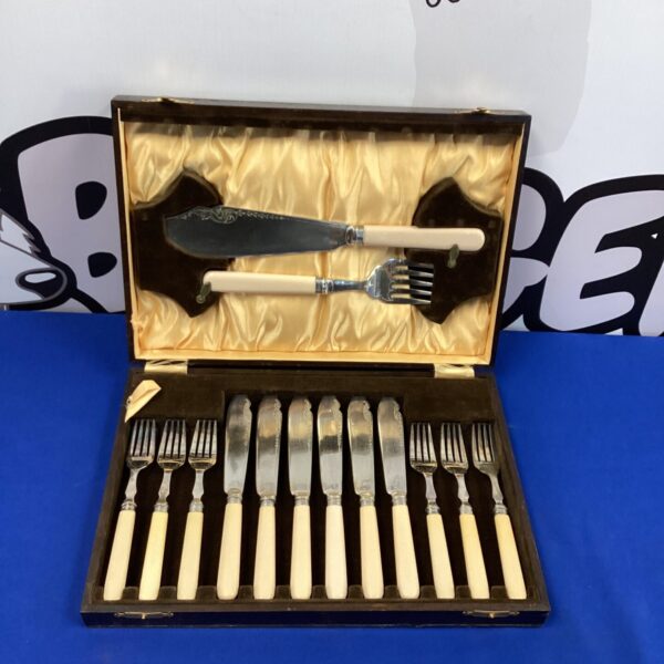 Vintage silverplate fish fork and knife set with mother of pearl handles.