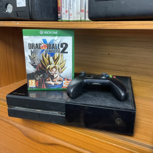 Microsoft Xbox One console with controller and game displayed.
