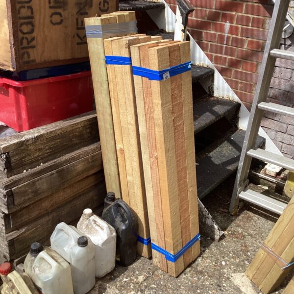Three bundles of timber strapped together for easy handling.