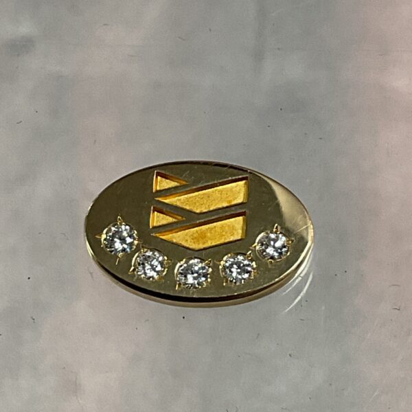Gold Chevron Oils pin with sparkling diamonds, vintage collectible.